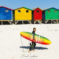 Surfeuse devant les cabanes de plage